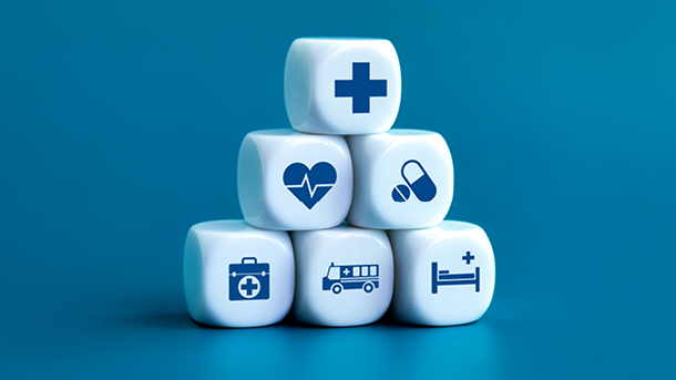 Six dice stacked in a pyramid with medical icons
